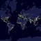 World map in shades of indigo and blue with population centers shown as clusters of golden light
